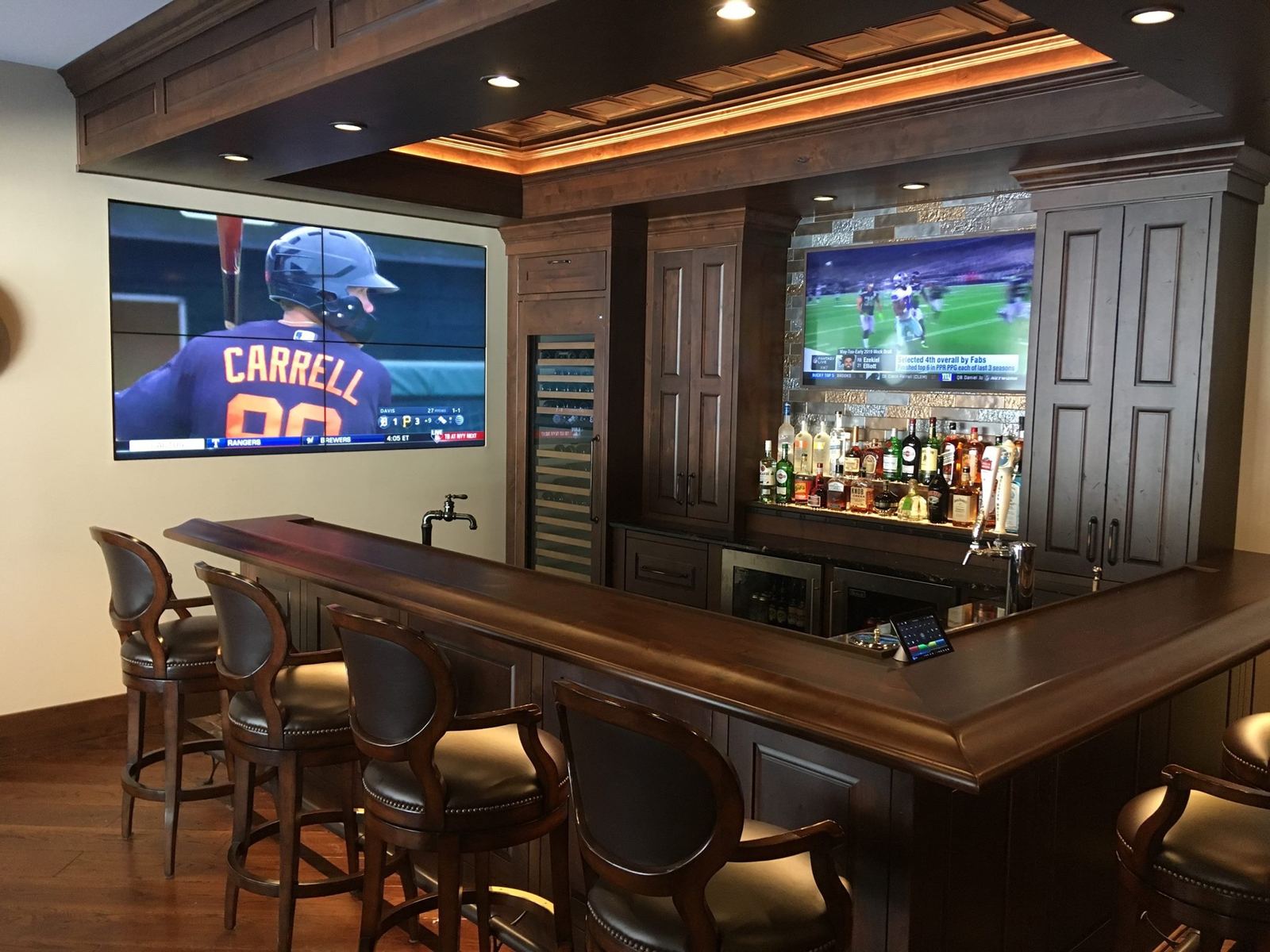 Custom home bar with video wall and mounted TV